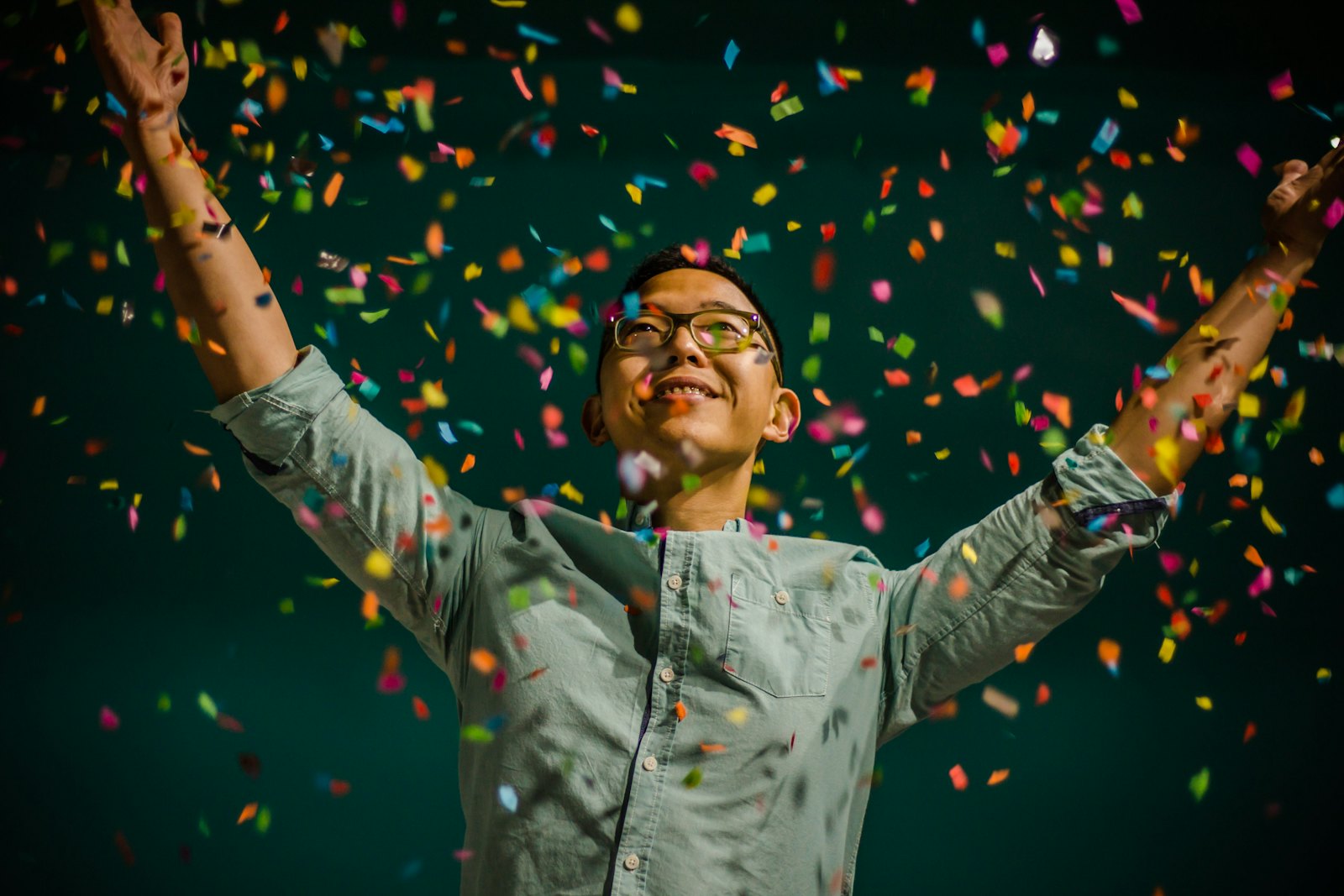 Man celebrating under falling confetti