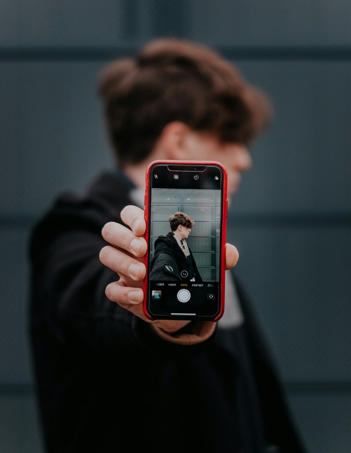 Hand holding a phone recording
